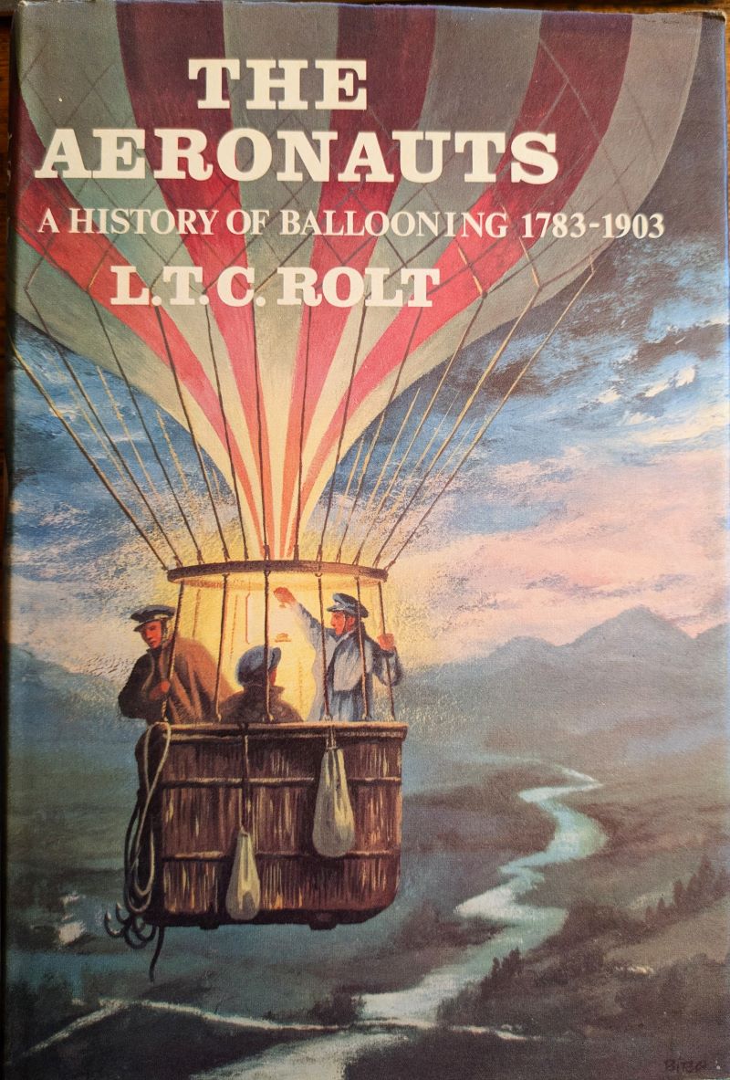 Picture of book cover showing colour painting of 19th century balloon in the evining sky with basket's 3 occupants illuminated by a suspended lantern.